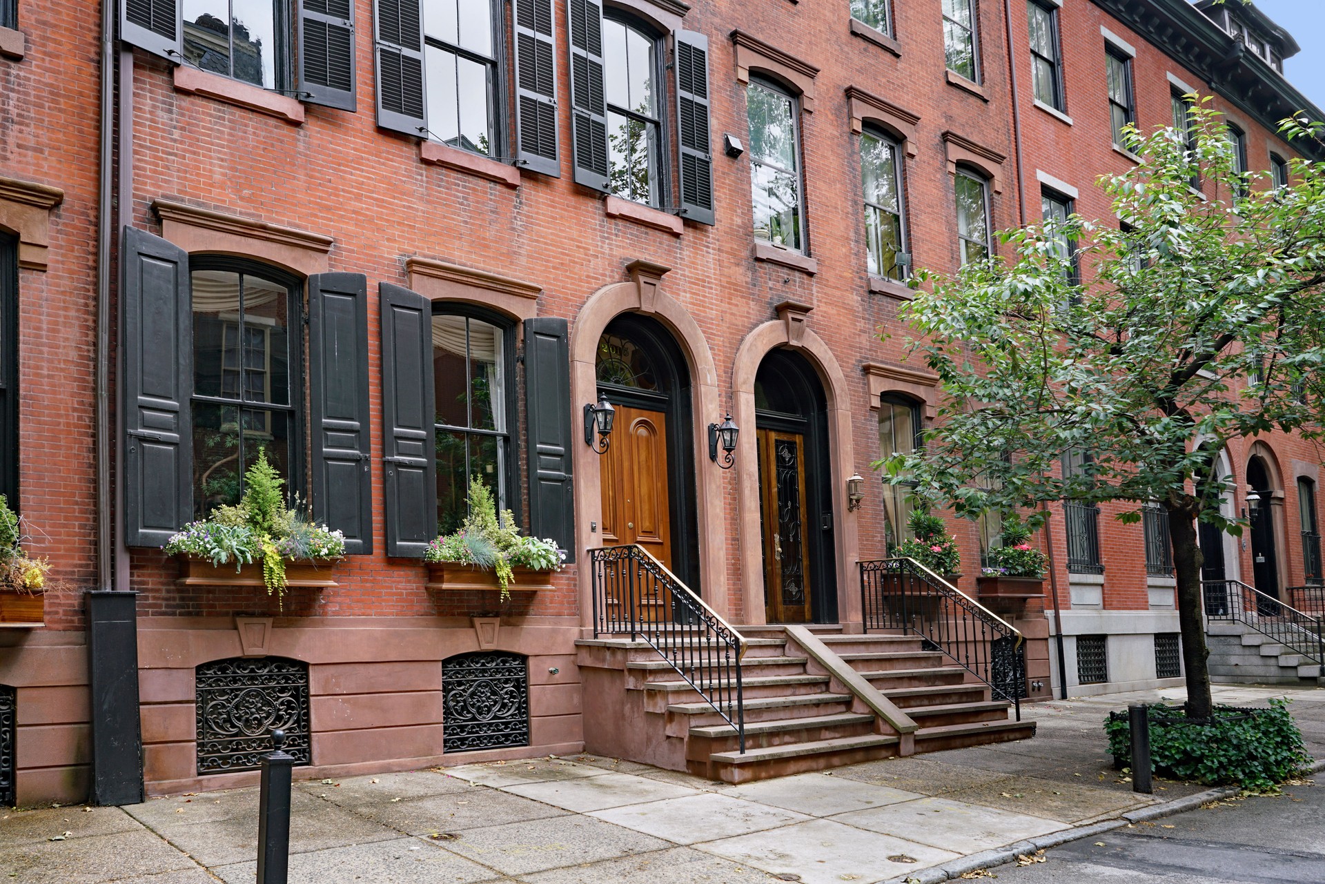 Street with elegant old brick brownstone style townhouses